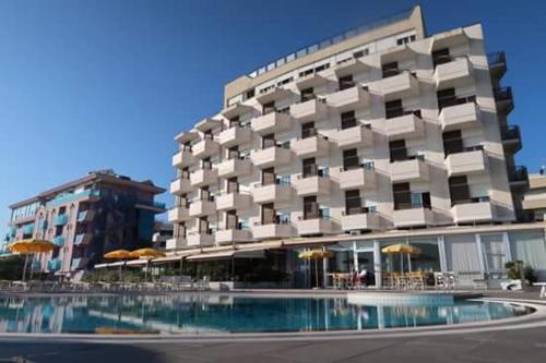 
a large building with a large pool of water in front of it at Hotel David in Cesenatico
