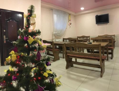 a christmas tree in a room with a dining room at Malva in Lviv