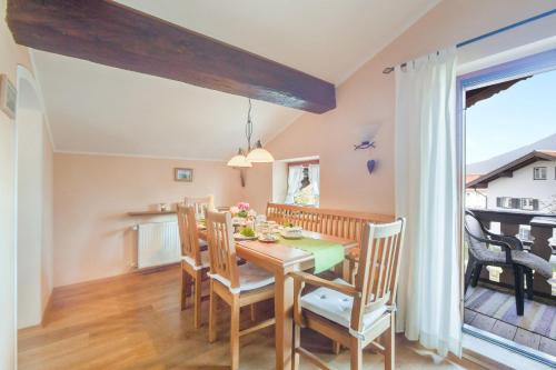 a dining room with a wooden table and chairs at Beim Kreuzfelder Zwiesel in Inzell