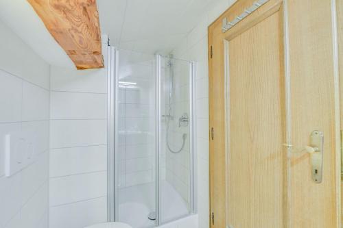 a shower with a glass door in a bathroom at Beim Kreuzfelder Zwiesel in Inzell