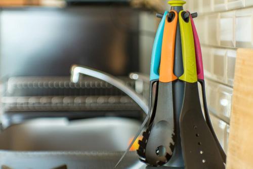 a group of colorful kitchen utensils in a holder at Villa Kamakura in Kamakura