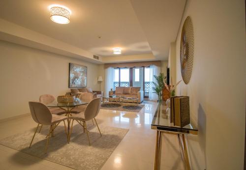 a living room with a table and chairs at Private Beach, Resort Living Kingdom of Sheba in Dubai