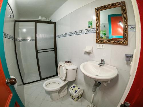 a bathroom with a shower and a toilet and a sink at Jardín by Bernalo Hotels in Jardin