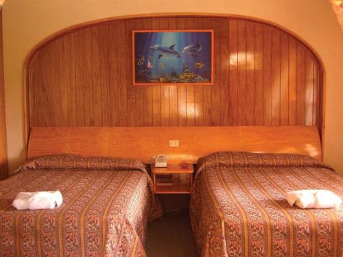 Cama o camas de una habitación en Hotel Arrecife de Coral