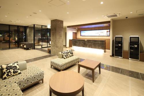 a lobby with two couches and a table at AB Hotel Osaka Sakaisuji Hommachi in Osaka