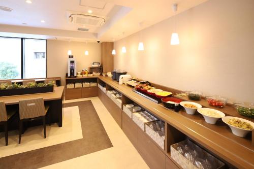 a kitchen with a buffet with food on it at AB Hotel Osaka Sakaisuji Hommachi in Osaka