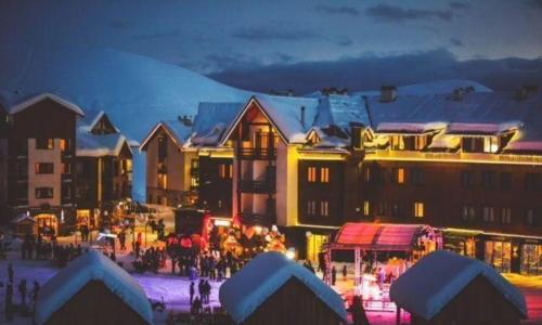 a group of buildings with christmas lights at night at New Gudauri Suites by Gudauri Travel in Gudauri