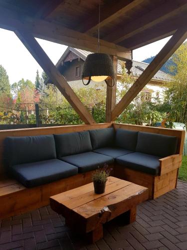a couch and a coffee table on a patio at Villa Zeppelin - App Smaragd in Bramberg am Wildkogel