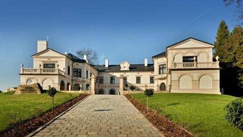 a large white house with a driveway at Zámek Wichterle - Hotel a pivní lázně in Slavičín