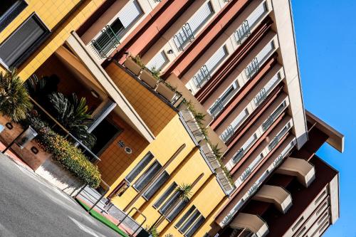 a yellow building with plants on the side of it at Hotel Quadrifoglio in Cagliari