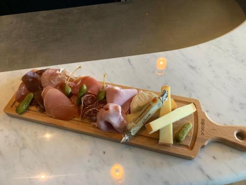 a plate of food with meats and cheese on a table at Hotel Victoria in Valence