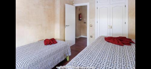 a bedroom with two beds with red bows on them at Villa Campito in El Puerto de Santa María