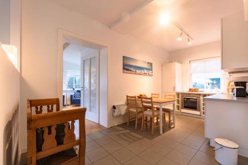 a kitchen and dining room with a table and chairs at Hof Garz in Poseritz