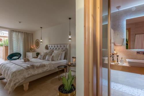 a bedroom with a large bed and a bathroom at Stelios Gardens in Malia