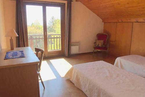 a bedroom with two beds and a balcony with a window at Cosmic Latte in Divonne-les-Bains