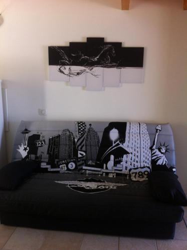 a black couch with black and white pillows on it at Peri village in Peri