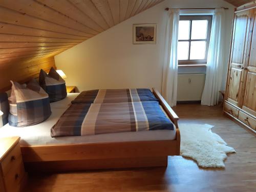 a bedroom with a large bed with a wooden ceiling at Ferienwohnung Franzi in Garmisch-Partenkirchen