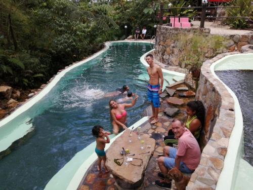 a group of people in a pool at a resort at Finca de la Vaca - Family House in Mera