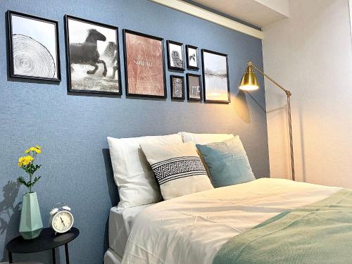 a bedroom with a bed with pictures on the wall at Alo BnB 6 - Near IKEBUKURO, SHINJUKU, UENO, AKIHABARA - Self check-in in Tokyo