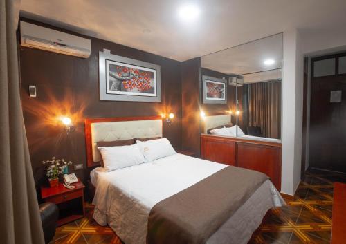 A bed or beds in a room at D´Milez Hotel
