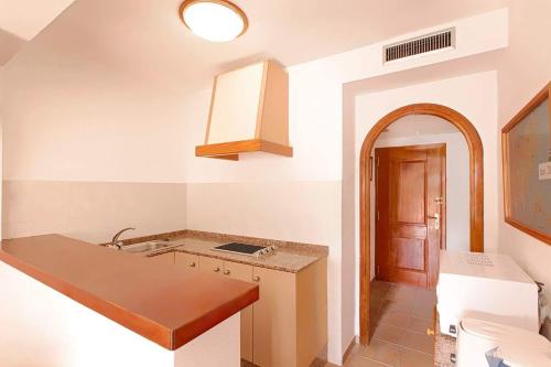 a kitchen with a sink and a counter top at Apartamentos Colomar in Es Figueral Beach