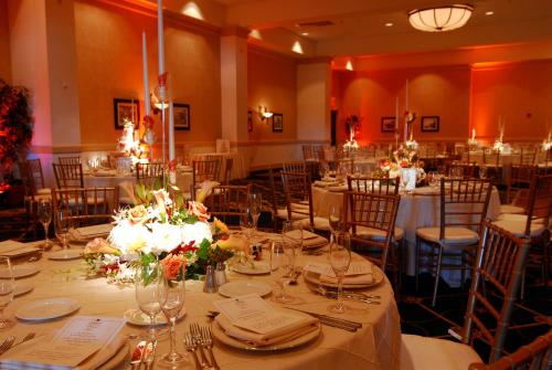a dining room with tables and chairs with plates and glasses at Seaview, A Dolce Hotel in Galloway