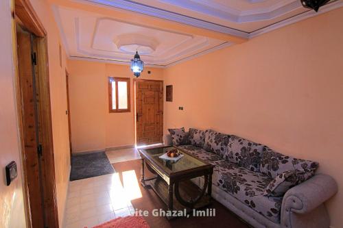 a living room with a couch and a table at Chez Ghazal Imlil in Imlil