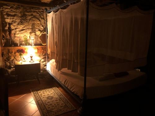 a bedroom with a bed and a table with a lamp at B&B Podere Camaiano in Roccastrada