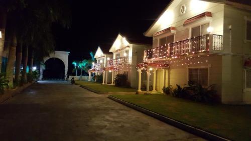 a building with christmas lights on it at night at Sai Maa Resort And Convention Centre in Puttaparthi