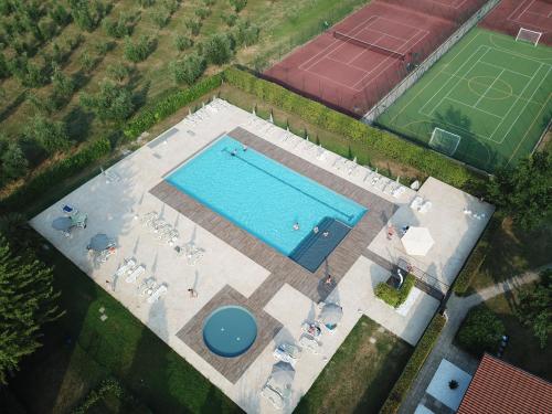an overhead view of a swimming pool with chairs and a field at Agriturismo La Filanda in Manerba del Garda