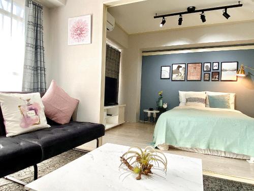 a living room with a bed and a couch at Alo BnB 6 - Near IKEBUKURO, SHINJUKU, UENO, AKIHABARA - Self check-in in Tokyo
