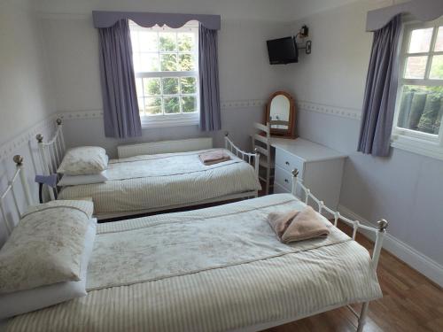 En eller flere senge i et værelse på Rose Cottage
