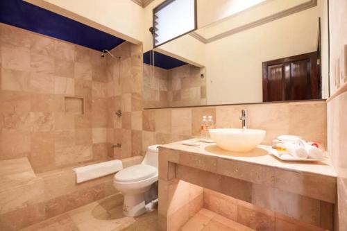 a bathroom with a sink and a toilet at Orchidelirium Casa Hotel & Salud Estética in Cuernavaca