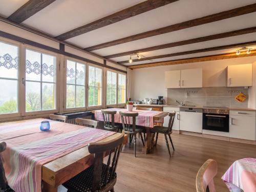 a kitchen and dining room with tables and chairs at Ferienwohnung in Todtmoos in Todtmoos