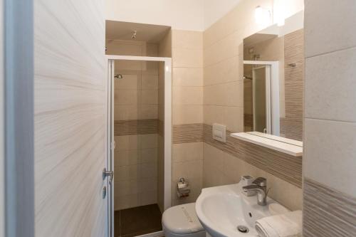 a bathroom with a sink and a toilet and a mirror at Spuma di mare in Gallipoli