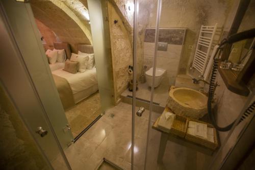 a bathroom with a shower and a sink in a room at Dokya Hotel in Ürgüp