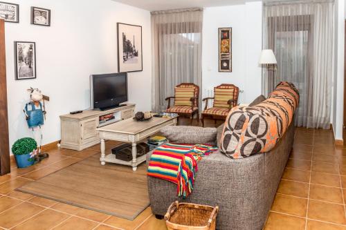 a living room with a couch and a tv at Casa Santa Ana in Ajo