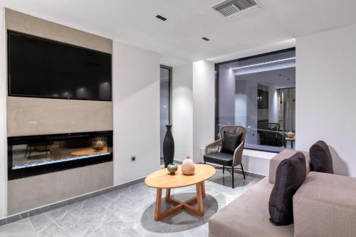 a living room with a couch and a table at LAS HOTEL & SPA in Gythio