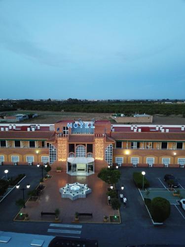 an aerial view of a building with a parking lot at Hotel Torre De Los Guzmanes in La Algaba