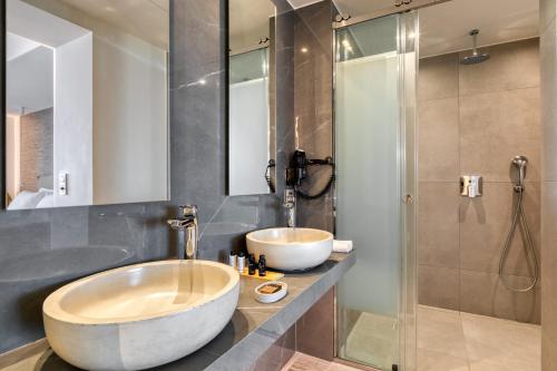 a bathroom with a tub and a sink and a shower at LAS HOTEL & SPA in Gythio