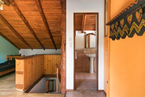 a bathroom with a sink and a toilet in a room at Hostel El Mirador in El Bolsón