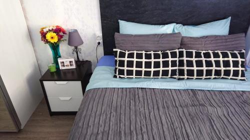 a bedroom with a blue bed with a vase of flowers on a table at Apartment El Dorado in Playa de las Americas