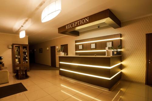 a hotel lobby with a reception desk and a sign at Maria Garden hotel & restaurant in Ivano-Frankivsʼk