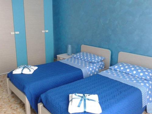 Ένα ή περισσότερα κρεβάτια σε δωμάτιο στο CASA VACANZE I BIGIONI