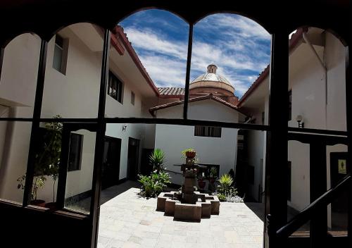a view of a courtyard of a building from a window at Hotel Santa Maria in Cusco