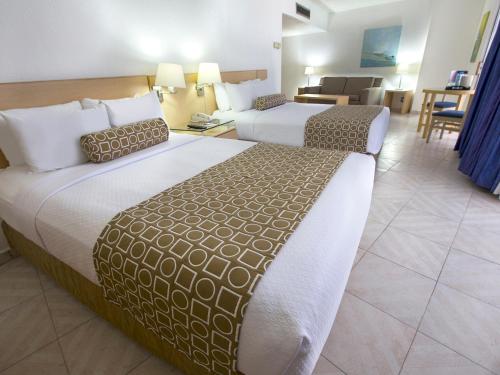 Ένα ή περισσότερα κρεβάτια σε δωμάτιο στο HS HOTSSON Hotel Acapulco