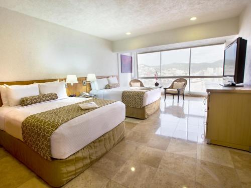 Ένα ή περισσότερα κρεβάτια σε δωμάτιο στο HS HOTSSON Hotel Acapulco