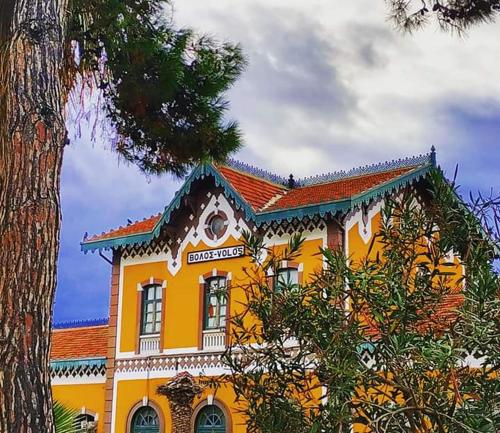 a large yellow building with a red roof at Volos Center Luxury Home in Volos