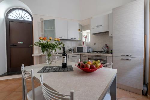 una cocina con una mesa con un bol de fruta. en Casa Vacanza da Giggino, en Ravello