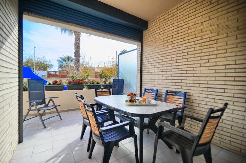 a patio with a table and chairs on a balcony at APARTAMENTO AMPLIO. VISTAS A LA PLAYA in Puzol